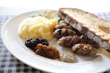 Grilled sausage with bread and potato and fruit jam sauce cuisine