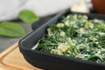 Tasty spinach dip on table, closeup view