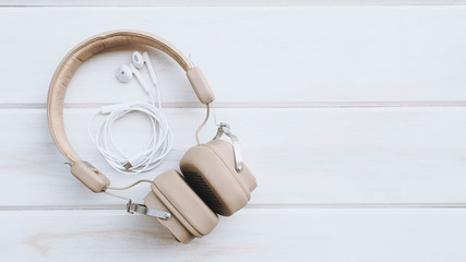 concept top view, two headphones on a white wooden table
