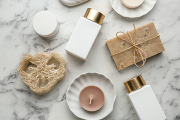 Flat lay composition with spa supplies on marble table