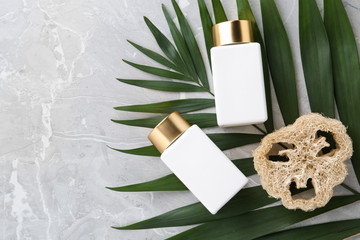 Flat lay composition with jars for cosmetic products on grey table. Spa supplies