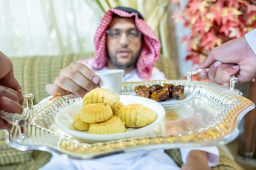 Arabic man serving coffee