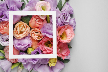 Flat lay composition with beautiful Eustoma flowers on grey background