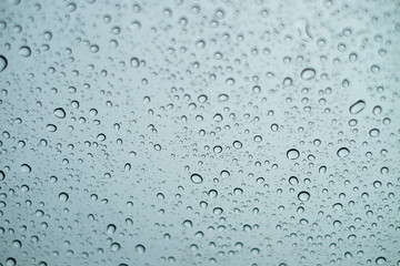 Water drops on the glass on a rainy day