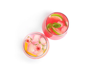Glasses of tasty refreshing drinks on white background, top view