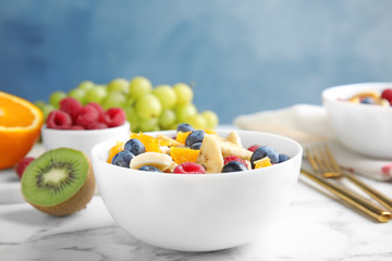 Fresh tasty fruit salad on white marble table