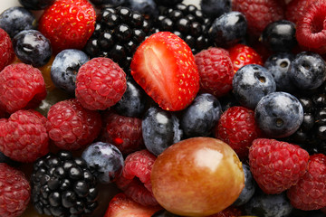 Fresh tasty fruit salad as background, top view