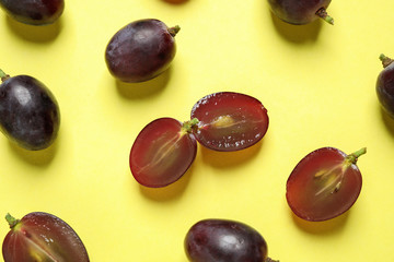 Flat lay composition with fresh ripe juicy grapes on yellow background