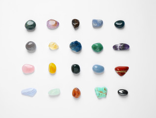 Different gemstones on white background, top view