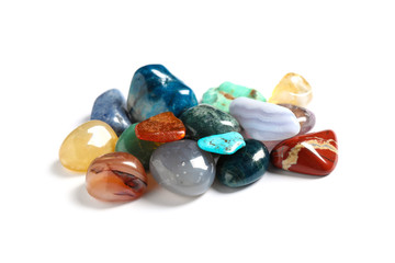 Pile of different beautiful gemstones on white background
