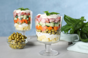 Delicious homemade salad Olivier on light table