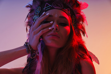 Woman in carnival suit isolated with neon lights.