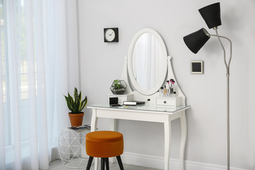 Fototapeta na wymiar Dressing table with mirror in stylish room interior