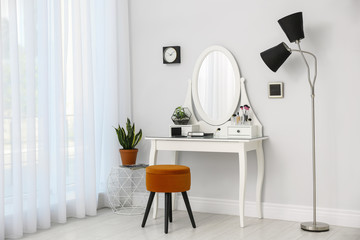 Dressing table with mirror in stylish room interior