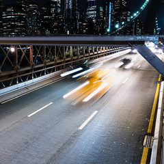 Vehicles on bridge with motion blur at night