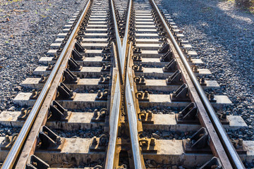 Close up of redirection train or railroad tracks with cement backing In the countryside Thailand