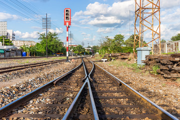 Railway tracks with traffic lights in countryside Thailand