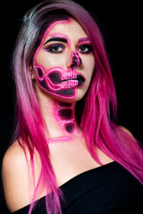  Halloween. Woman in day of the dead mask skull face art. Pink and black skull make up.