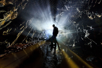 Silhouette of a man in an abandoned mine