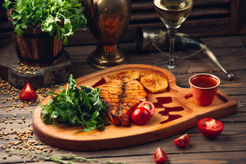 fried salmon with potatoes and vegetables