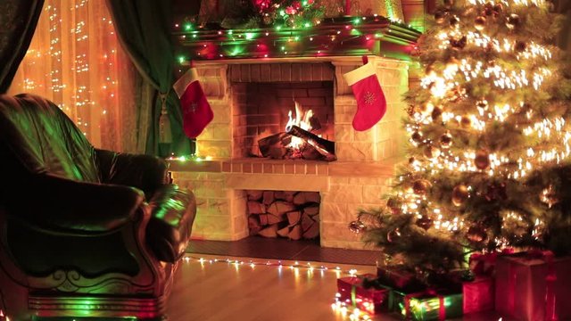 Christmas decorated interior with fireplace, armchair, window and xmas tree
