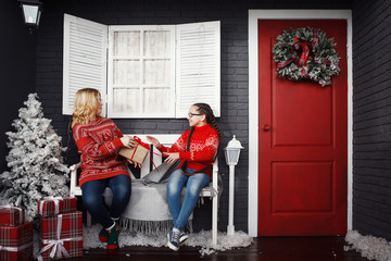 Teenage girls in a red Christmas sweater.