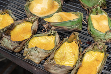 Roasted eggs in a container made from banana leaves