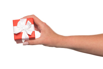 Hands holding a beautiful gift box, woman gives a gift, isolated on white background