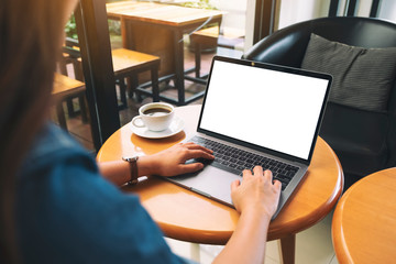 Mockup image of a woman using and typing on laptop keyboard with blank white desktop screen