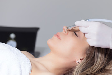 woman face skin treatment in beauty health clinic close