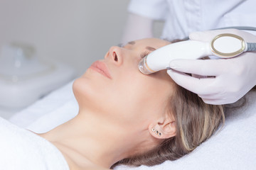 woman face skin treatment in beauty health clinic close