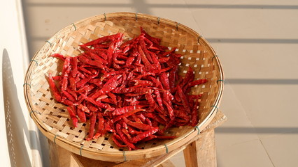 dried chili in a bamboo basket on chair , Thai cooking ingredients