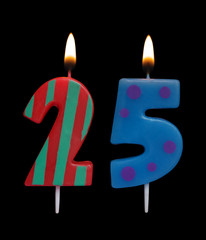 Burning colorful birthday candles on black background, number 25