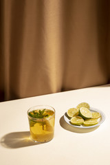 Slices of lemon with cocktail drink over white desk