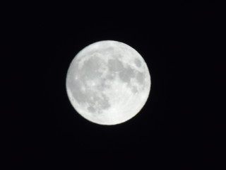 Genova, Italy - 09/13/2019: An amazing photography of the full moon over the city of Genova by night with a great clear sky in background and some stars