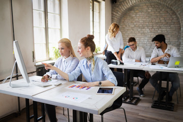 Successful happy group of people learning software engineering and business during presentation
