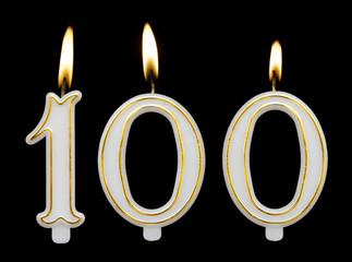 Burning birthday candles isolated on black background, number 100