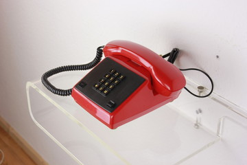 old retro telephone red green plastic isolated on white background side view front view with cable  reciever handset digits dial. Communication old fashioned classic 60s 70s