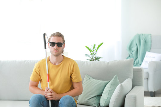 Blind young man at home