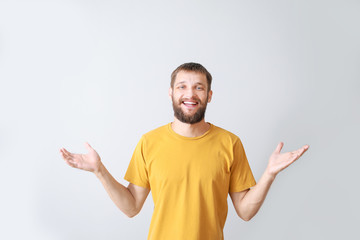 Fototapeta premium Portrait of happy young man on grey background