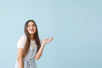 Portrait of happy young woman on color background