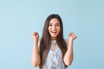 Portrait of happy young woman on color background