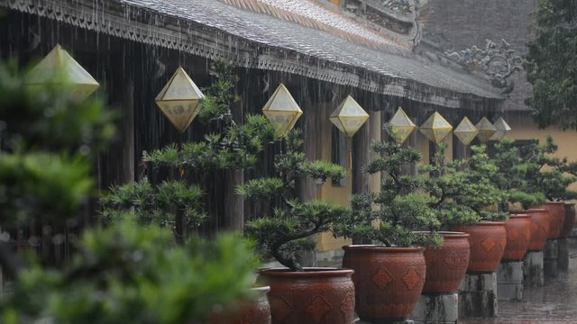 Traditional paper lanterns of Hue city getting wet under heavy monsoon rain.