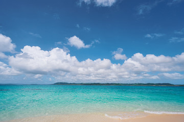 Fototapeta na wymiar Beautiful seascape. Sandy beach with blue clear water.