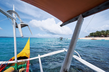 Travel by Philippines. Nose of traditional fishing boat sailng the mangrove sea lagoon.