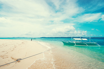 Beautiful landscape with tropical white sand beach with fishing boats. Siargao Island, Philippines.