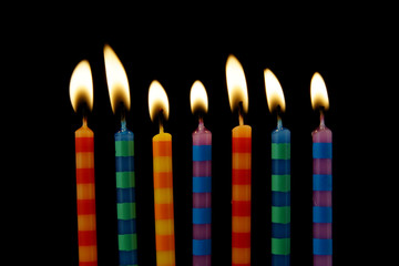 Burning birthday candles on black