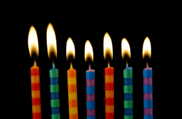 Stripped birthday candles on black background