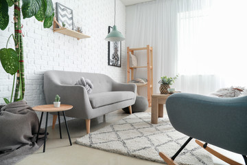 Stylish interior of room with soft couch