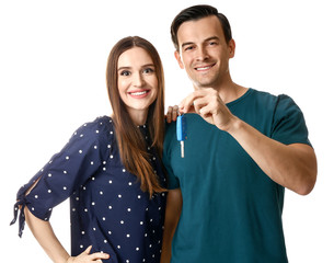 Happy couple with key from their new car on white background